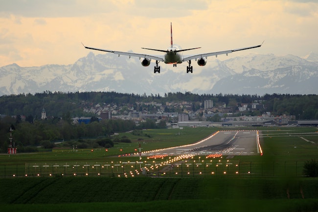 an airplane descending to runway in Switzerland