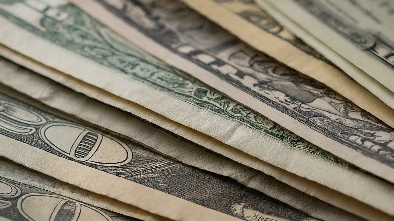 dollar bills zoomed in of different shades and colors