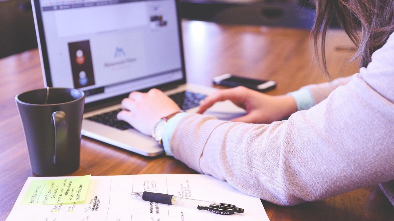 image of woman's hands on computer keyboard