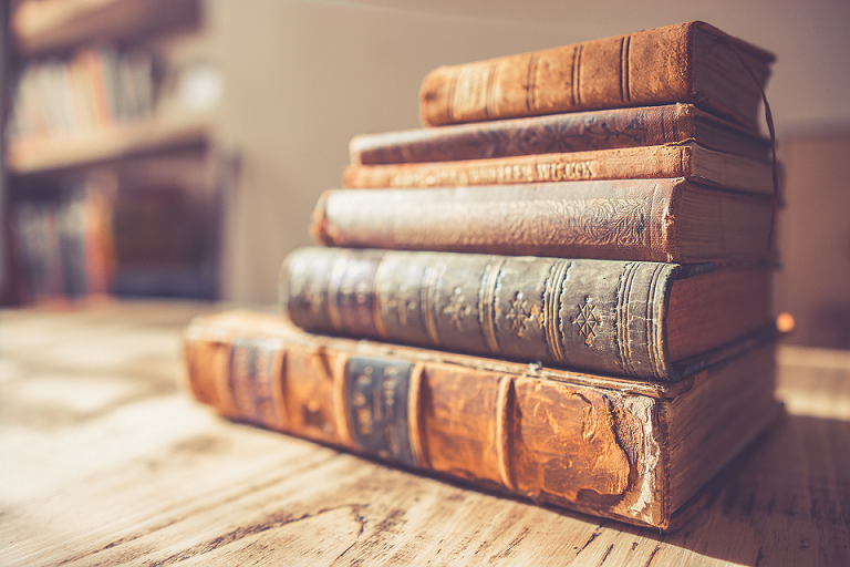 stack of six books on a coffee table